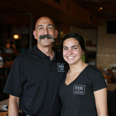 good food staff; bald man with large mustache and young woman smiling at camera