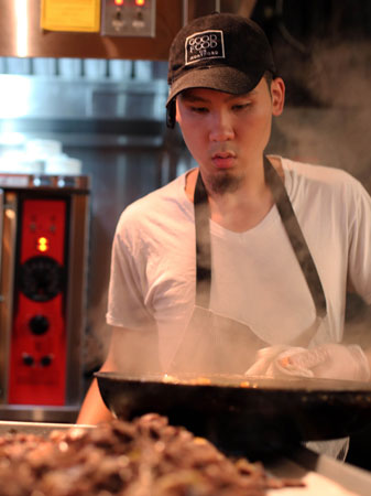 chef looking down on a steaming wok